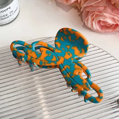 Versatile Elegant Dove Acetate Large Shark Clip demonstrating its stylish function as a headwear accessory for women.