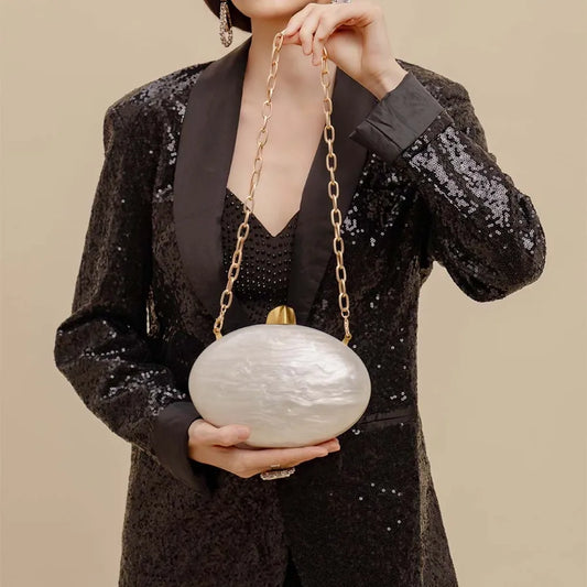 Luxury Elliptical Acrylic Evening Tote Bag featuring a sophisticated oval shape and crystal-clear design, highlighting its elegant chain strap and chic interior, perfect for weddings and fashion events.