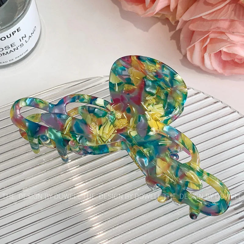 Display of the Elegant Dove Acetate Large Shark Clip in a sophisticated setting, perfect for chic women's hair fashion.