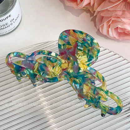 Display of the Elegant Dove Acetate Large Shark Clip in a sophisticated setting, perfect for chic women's hair fashion.