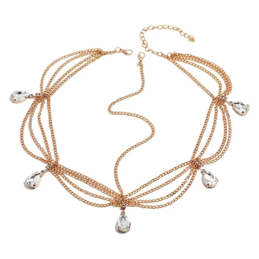 Opulent gold wave chain headband with graceful waterdrop tassels, designed for the modern woman's hair accessory collection.