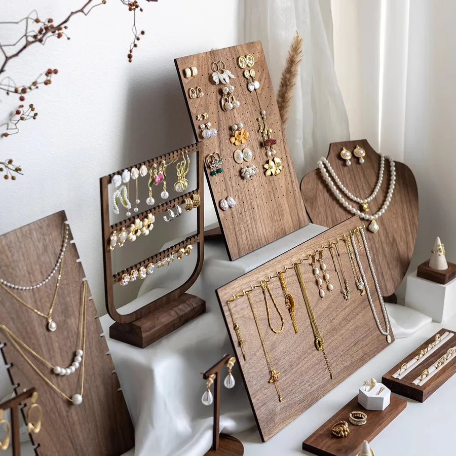 Sleek and elegant jewelry display stand made from walnut veneer, designed intricately for showcasing earrings and necklaces in a sophisticated manner.