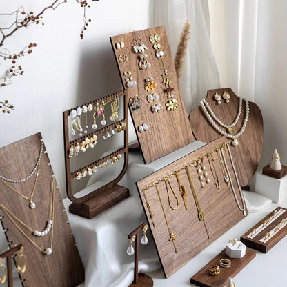 Sleek and elegant jewelry display stand made from walnut veneer, designed intricately for showcasing earrings and necklaces in a sophisticated manner.