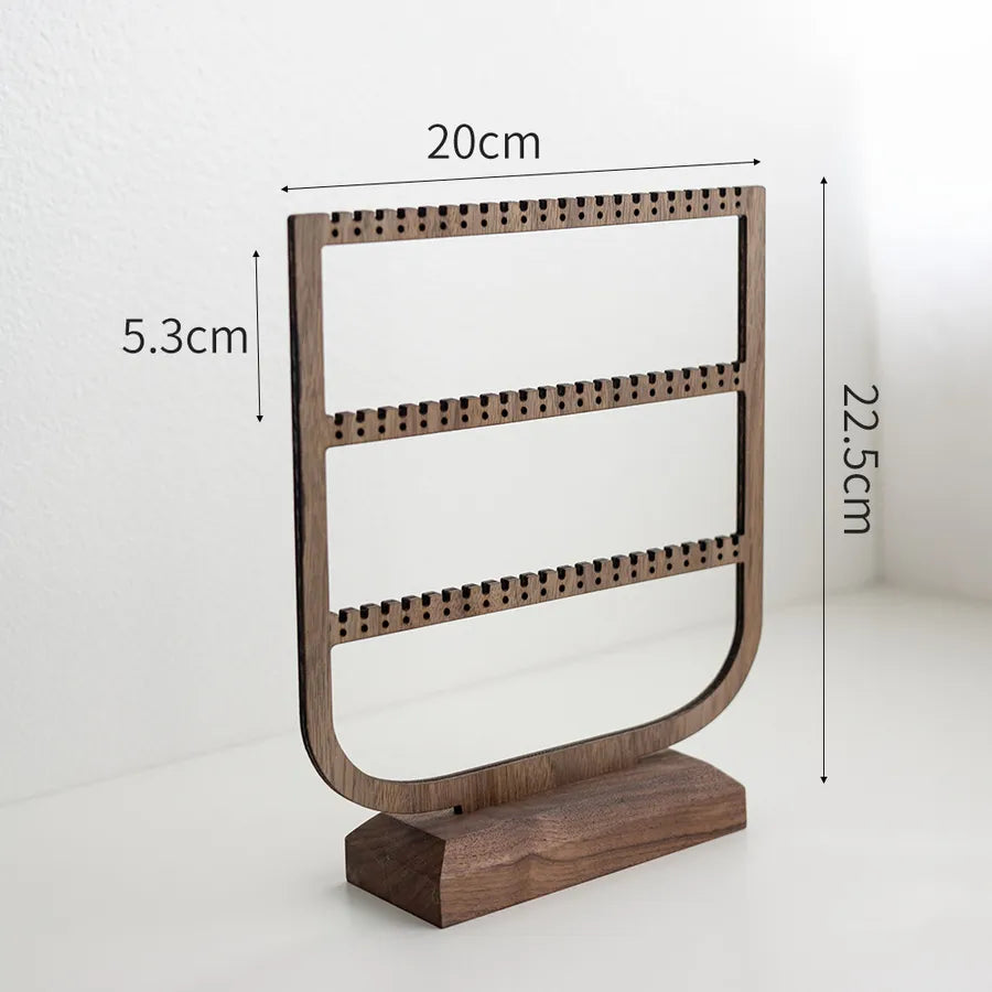 Chic jewelry organizer displaying multiple necklaces and earrings elegantly on a large capacity walnut stand, ideal for luxury collections.