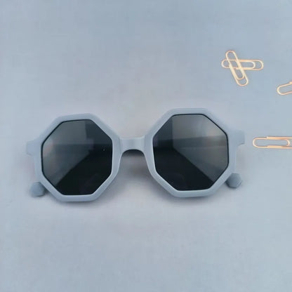 Trendy full-frame tinted sunglasses for kids with a unique polygon shape, perfect for stylish outdoor wear.