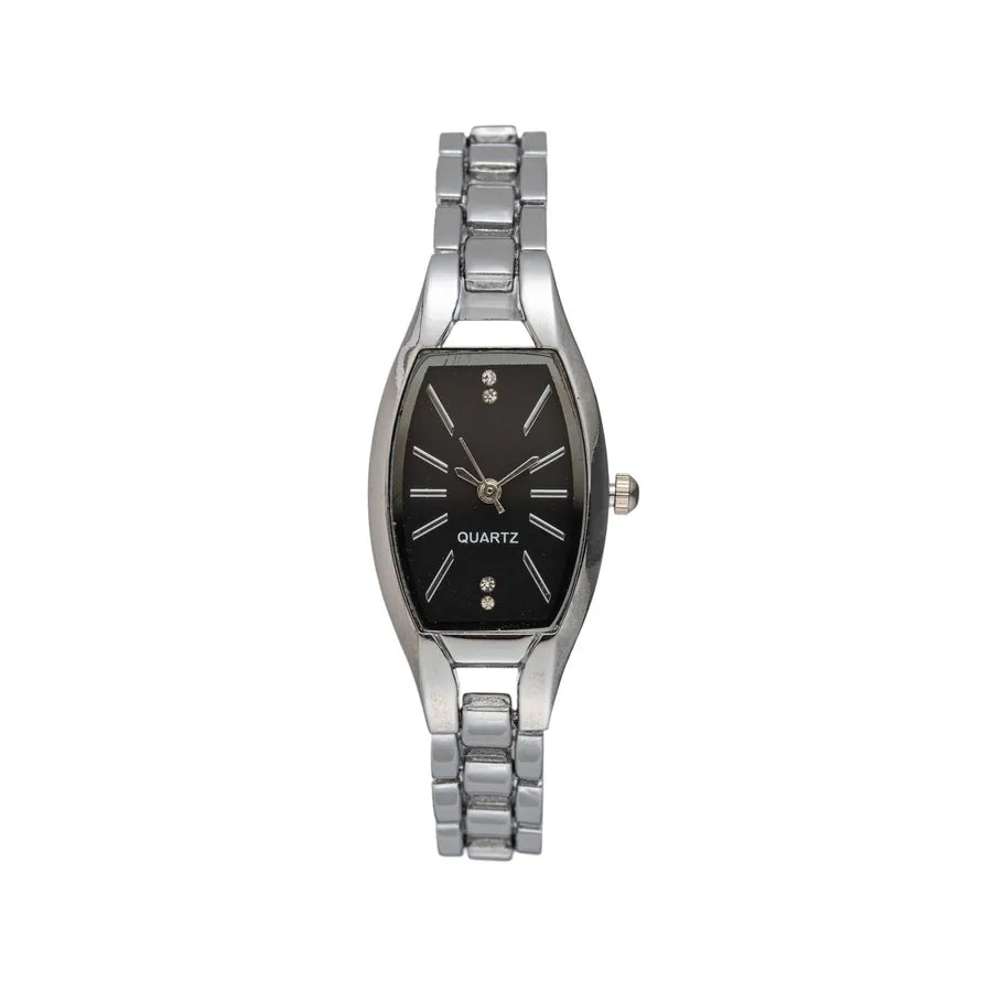 Stylish women's wrist adorned with a solid colour quartz watch, highlighting a smooth stainless steel strap and elegant pointer display, ideal for all seasons.