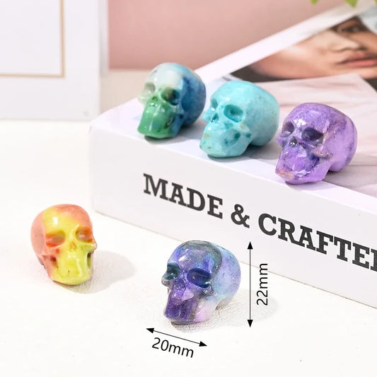 Elegant handmade skull ornament crafted from natural stone in sky blue and purple hues, perfect for sophisticated Halloween decorations.