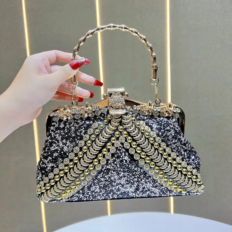 Fashionable yet functional square clutch evening bag with a single shoulder strap, designed in an elegant pillow shape with sparkling diamond accents.