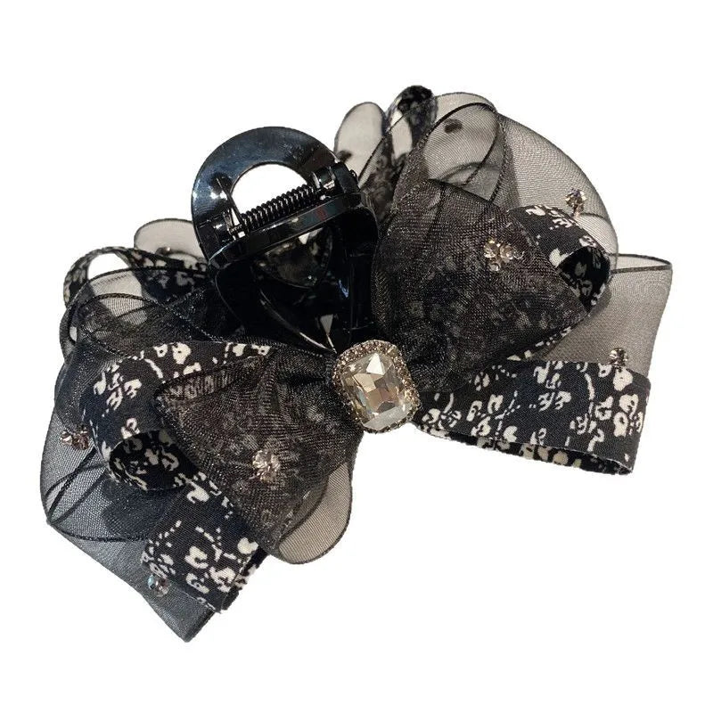 Stylishly arranged floral silk hair accessory showcasing the butterfly knot design, ideal for elegant women's hairstyles.