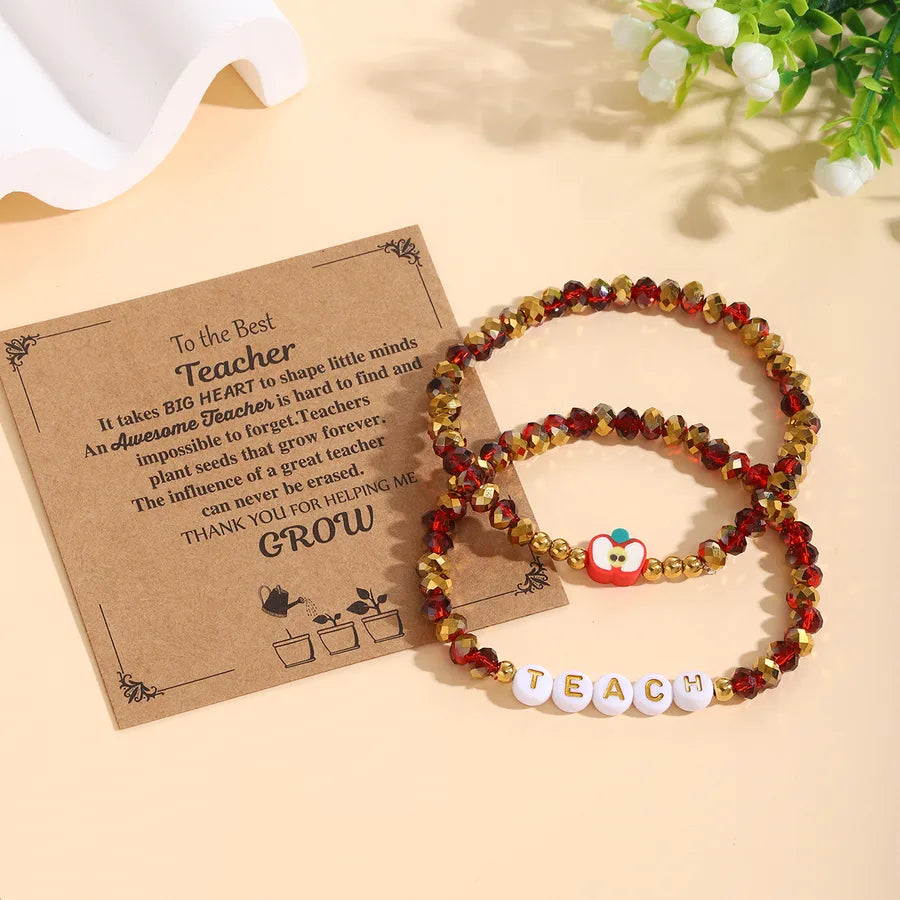 Close-up image of the beaded apple-themed bracelet set, featuring beautiful acrylic and glass beads designed for a sophisticated look.