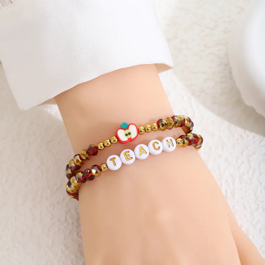 Elegant 2-piece elastic apple beaded bracelet set showcasing intricate design, perfect for gifting teachers across all seasons.