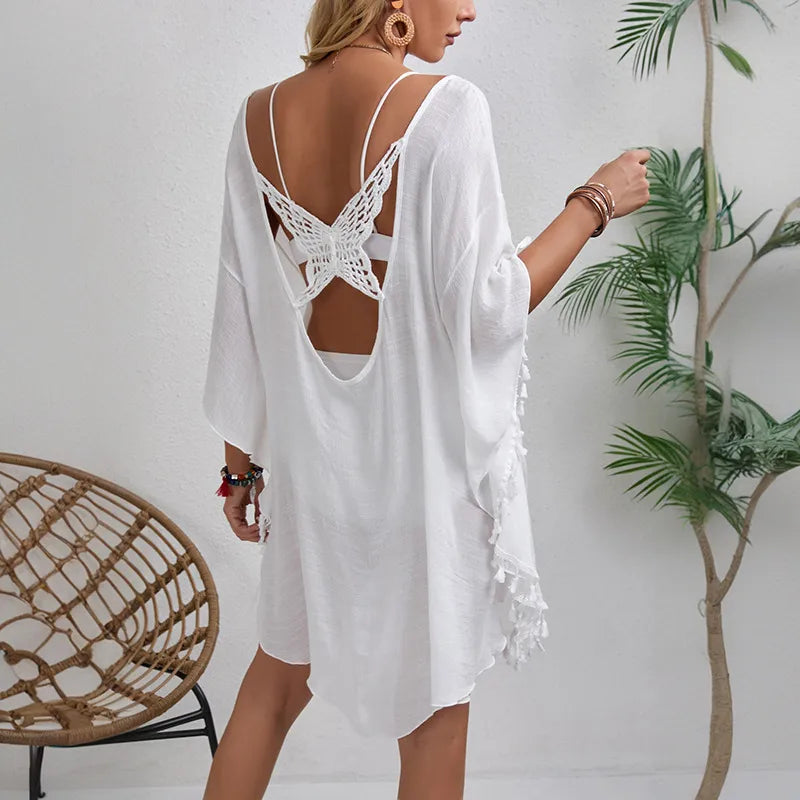 Chic and stylish women's summer cover up in solid colour, showcasing a U neck design and delicate half sleeves adorned with tassels, ideal for beach outings.