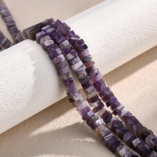 Elegant 6 x 3mm polished Amethyst tube beads in asymmetrical colour block design, featuring three strands of irregular natural stone for luxurious jewellery making.