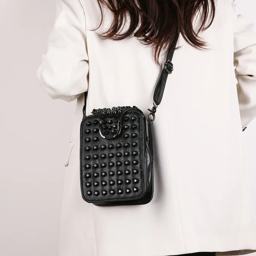 Chic square crossbody bag for women, adorned with stylish rivets, showcasing luxurious PU material.