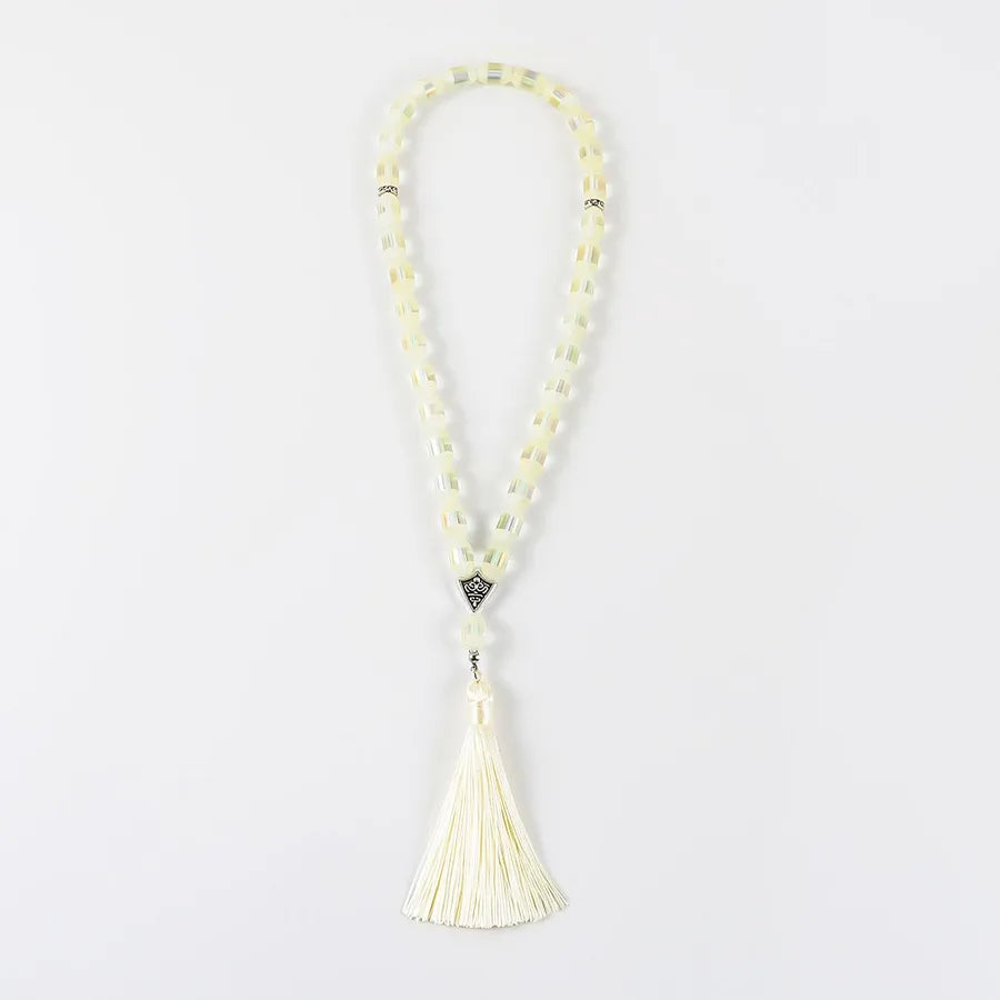 Close-up of a luxurious glass and alloy rosary with elegant tassels, suitable for Eid al-Fitr and sophisticated celebrations.