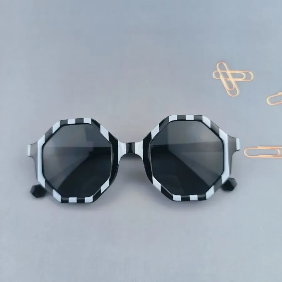 Stylish kids geometric polygon sunglasses featuring a full-frame design with tinted lenses, perfect for outdoor adventures.