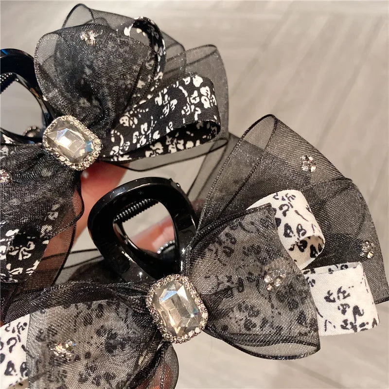 Elegant floral silk butterfly knot shark clip, a luxurious women's hair accessory featuring delicate pastel designs and a pastoral style.