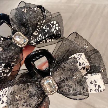 Elegant floral silk butterfly knot shark clip, a luxurious women's hair accessory featuring delicate pastel designs and a pastoral style.