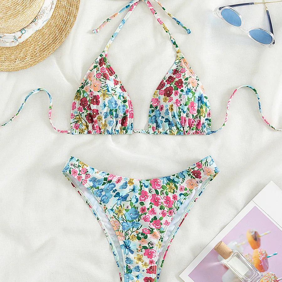 Luxury women's ditsy floral bikini swimwear set featuring triangle cups and low waist design, perfect for beach outings and poolside relaxation.