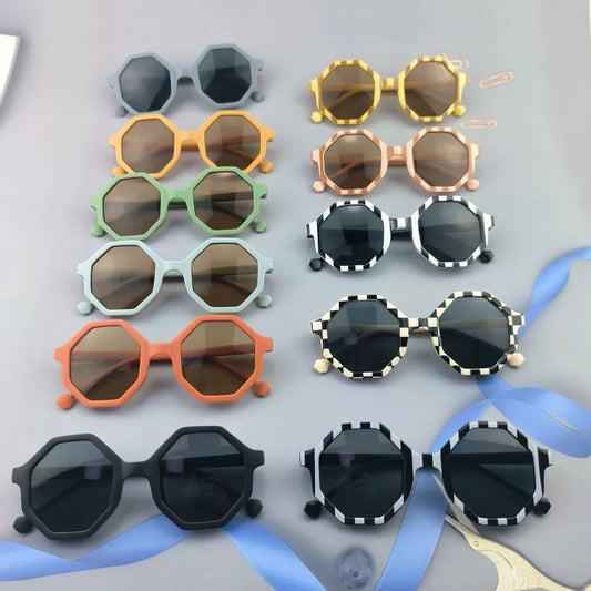 Luxury stylish kids geometric polygon sunglasses in vibrant colours for outdoor events.