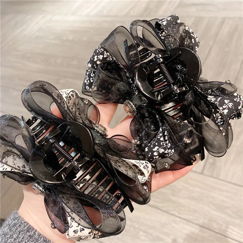 Close-up of the silk butterfly knot detail on an exquisite shark clip, perfect for adding a sophisticated touch to women's headwear.