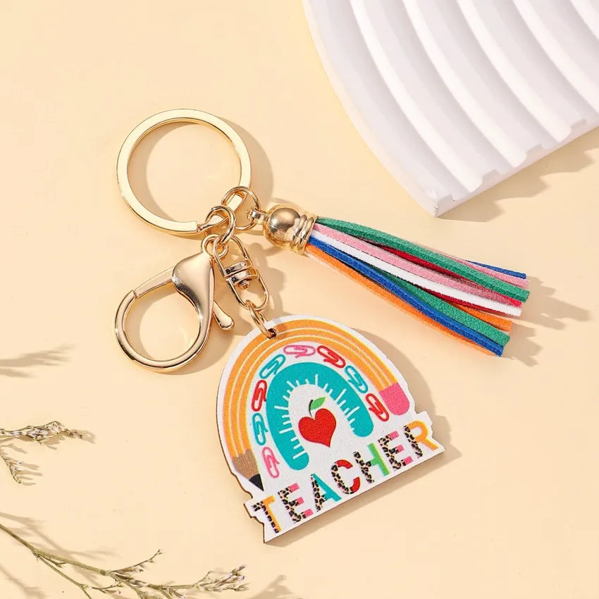 Elegant modern wooden keychain featuring a vibrant rainbow tassel, designed as a perfect unisex gift for Teachers' Day, symbolising appreciation and creativity in education.