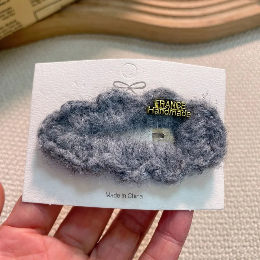 Sleek and sophisticated plush lamb fur bang holder for women's hair, designed for contemporary elegance.