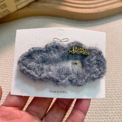 Sleek and sophisticated plush lamb fur bang holder for women's hair, designed for contemporary elegance.