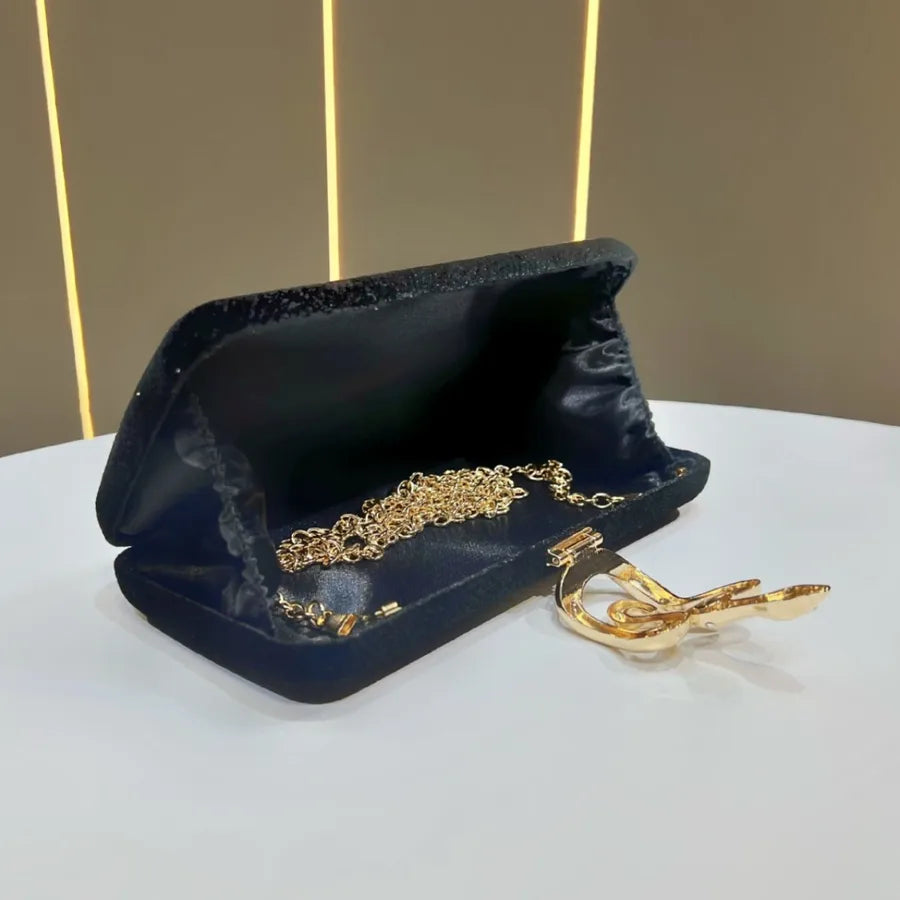 Exquisite small clutch bag crafted from soft velvet, highlighted by a fashionable snakeskin clasp, suitable for upscale events.