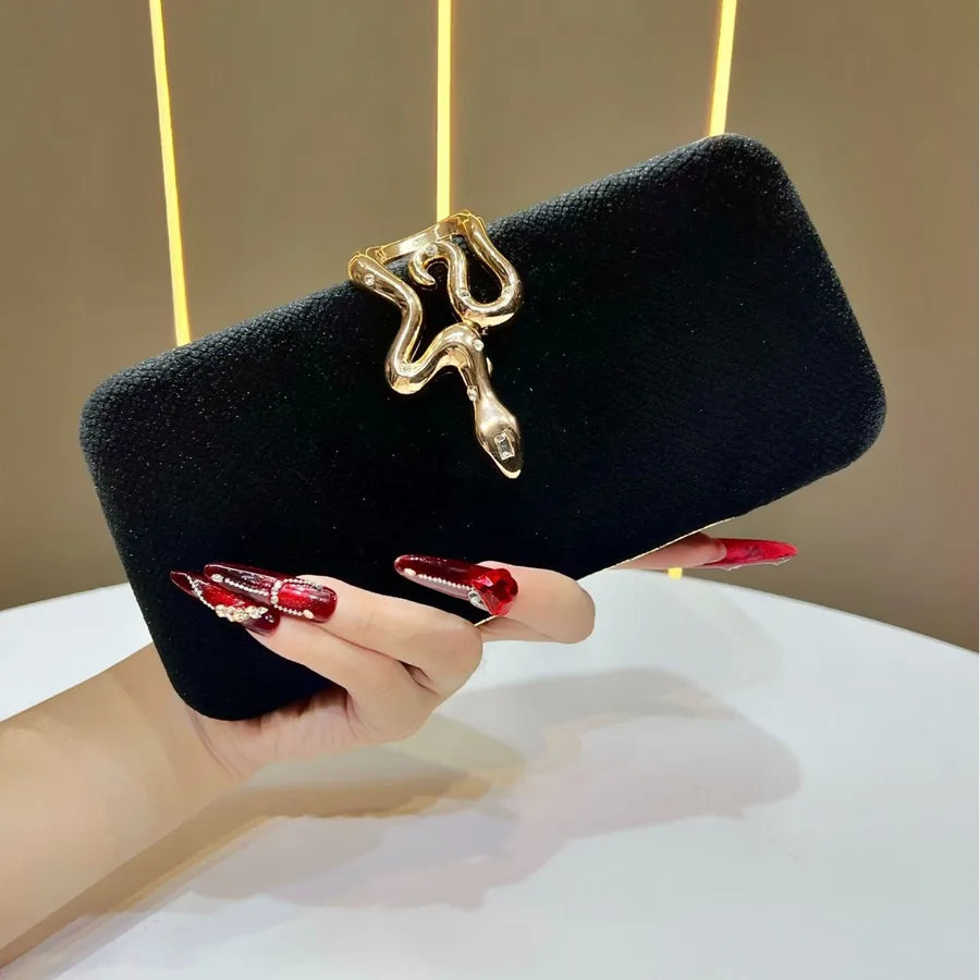Elegant velvet clutch bag featuring a stylish snakeskin lock, perfect for evening parties and dinners - luxurious box handbag for sophisticated occasions.
