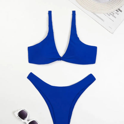 Fashion-forward women's solid colour swimwear set featuring a low waist bikini bottom and triangle bra cups, perfect for a luxurious beach getaway.