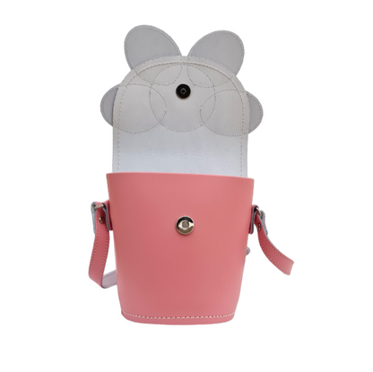 Stylish pastel pink leather barrel bag with adjustable strap, perfect for day-to-night transitions and designed for the modern fashionista.