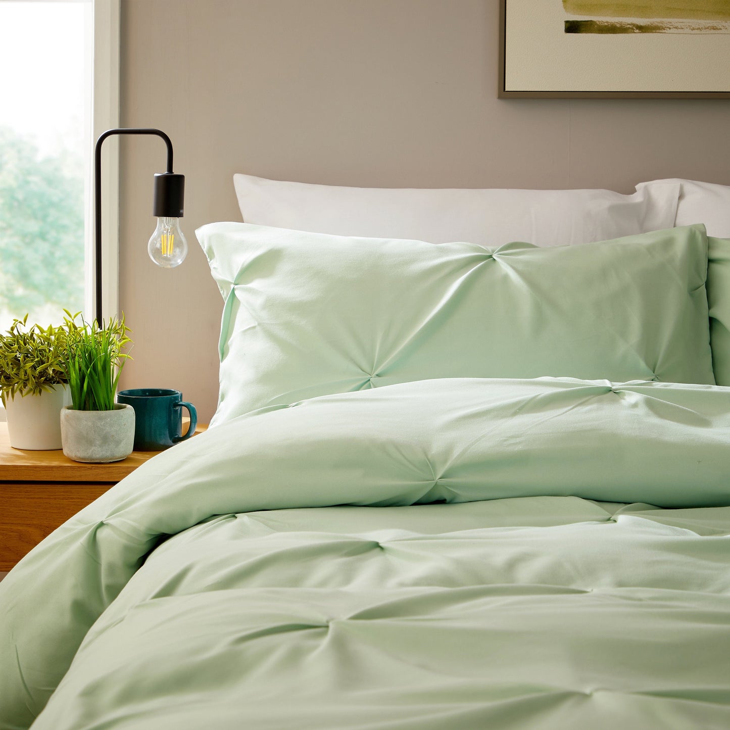 Close-up view of soft, breathable microfibre pillowcases in sage green from the OLIVIA ROCCO duvet cover set, showcasing exquisite craftsmanship and luxurious texture.