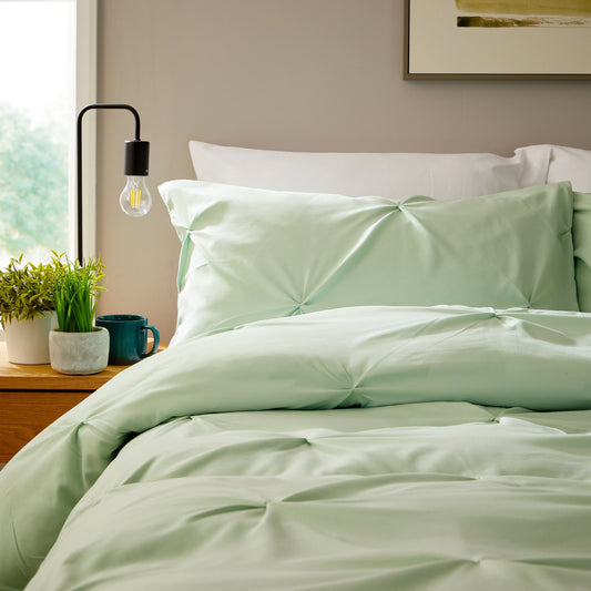 Close-up view of soft, breathable microfibre pillowcases in sage green from the OLIVIA ROCCO duvet cover set, showcasing exquisite craftsmanship and luxurious texture.