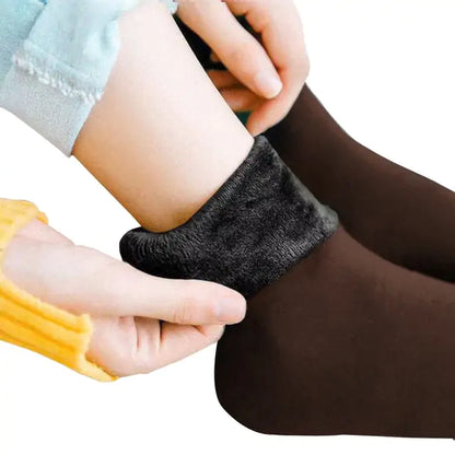 Luxury Women's Velvet Thermal Socks: Close-up of hands putting on soft, warm thermal socks in dark brown with plush velvet lining.
