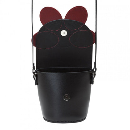 Elegant red handmade leather barrel bag featuring a poppy floral design against a chic black background, showcasing its luxurious craftsmanship and adjustable crossbody strap.