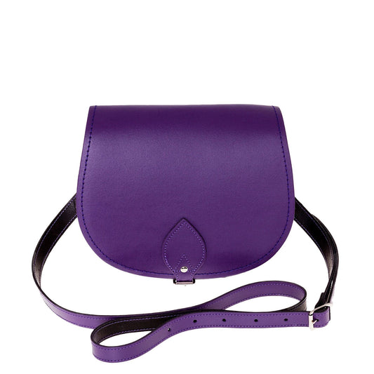 Handmade purple leather saddle bag showcasing its elegant craftsmanship and premium quality leather. Ideal accessory for adding a touch of luxury to any outfit.
