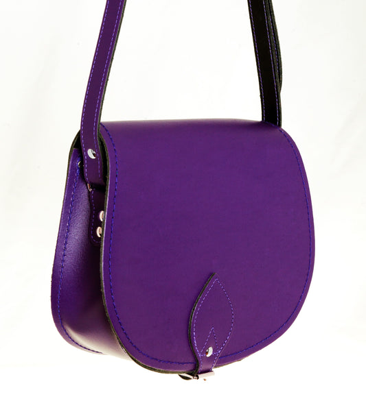 Close-up of the adjustable cross body strap of the purple leather saddle bag, highlighting its comfort and versatility for stylish, everyday use.