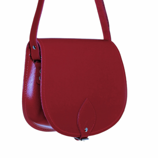 Luxury Handmade Red Leather Saddle Bag with Adjustable Cross Body Strap, showcasing fine craftsmanship and elegant design.