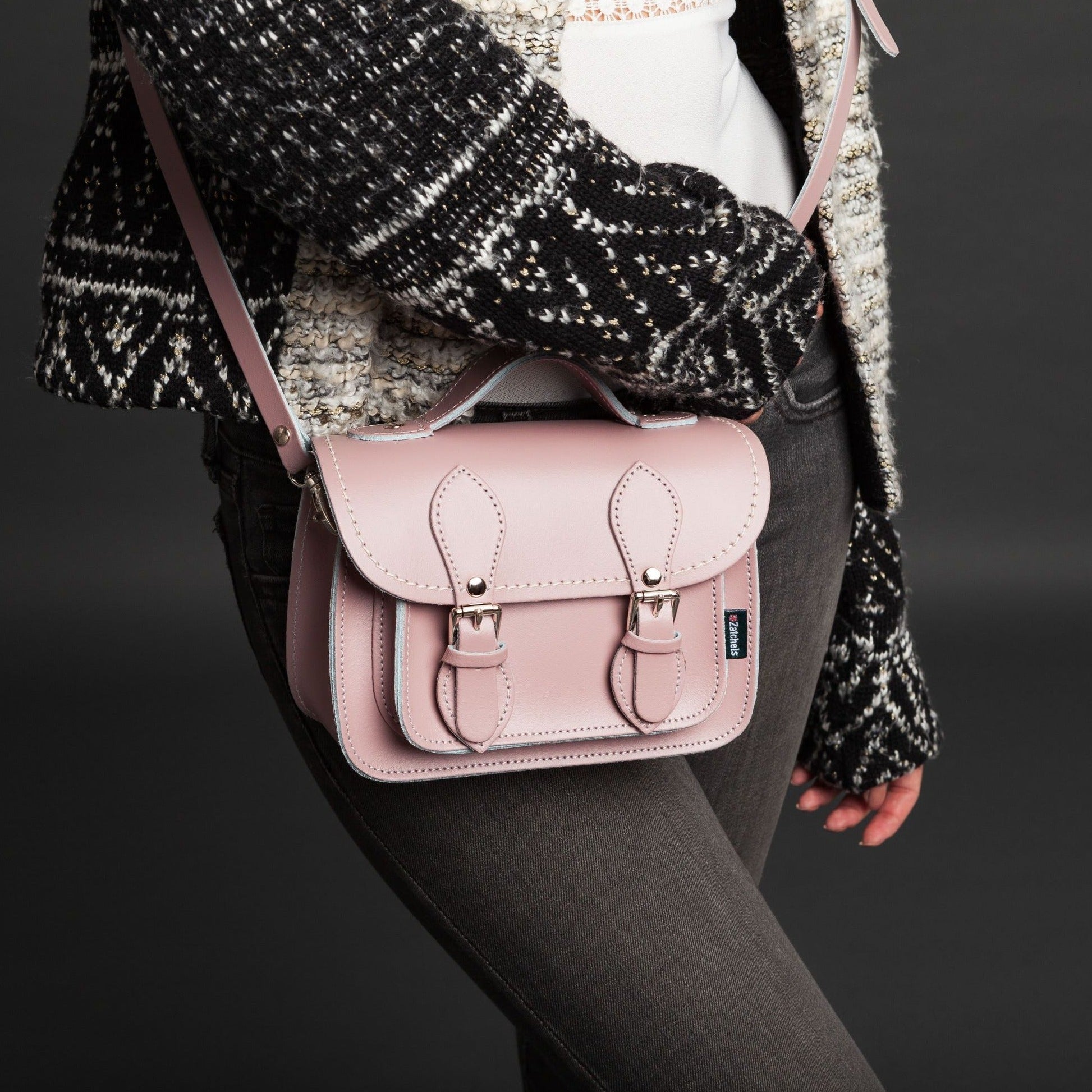 Handcrafted leather micro satchel from Zatchels displayed as a clutch, highlighting its refined design and exquisite pastel baby blue colour.