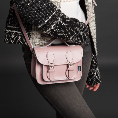 Handcrafted leather micro satchel from Zatchels displayed as a clutch, highlighting its refined design and exquisite pastel baby blue colour.