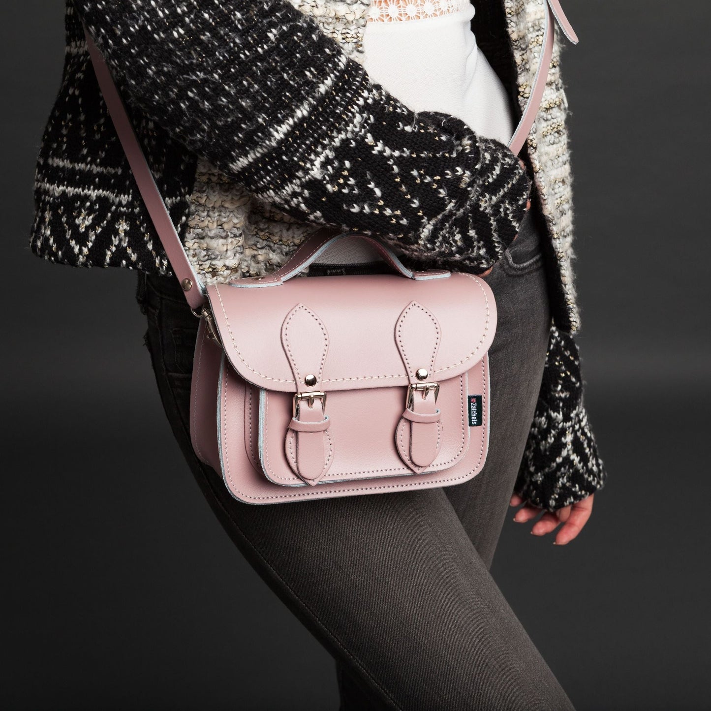 The micro satchel in pastel pink, showcasing its spacious interior designed for accommodating larger smartphones, available in small and Plus sizes.