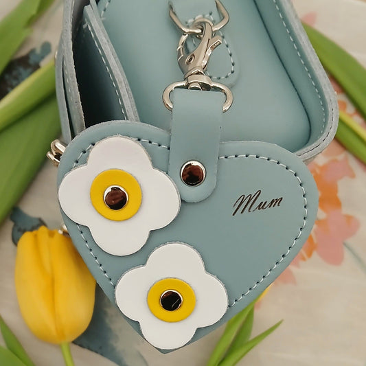 Close-up of the exquisite flower appliques and 'Mum' engraving on the Luxury Sea Green Love Heart Bag Charm, capturing its intricate design and craftsmanship.