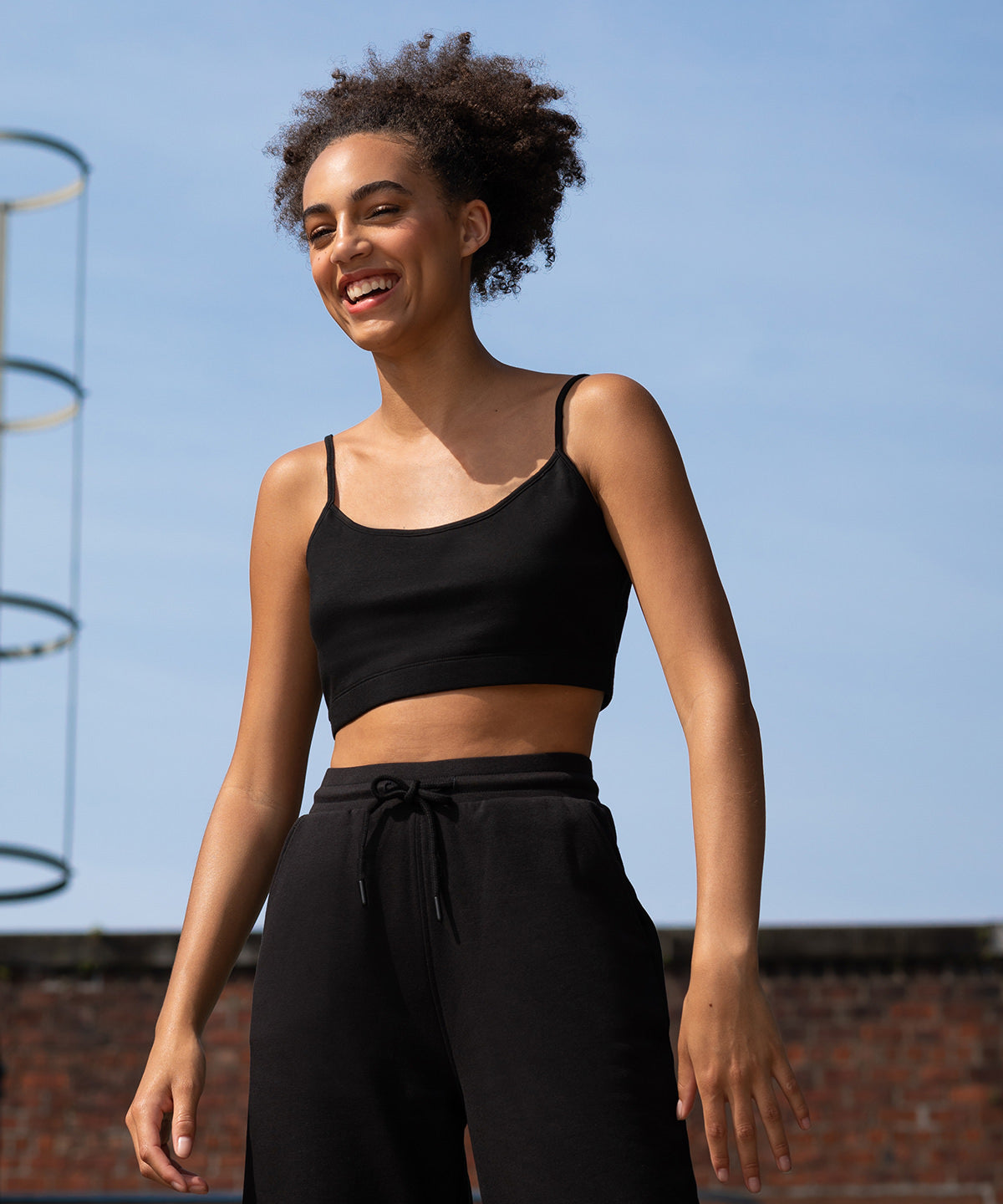 Luxurious cropped rPET cami top with adjustable straps, showcasing sustainable design in a soft cotton-polyester blend.
