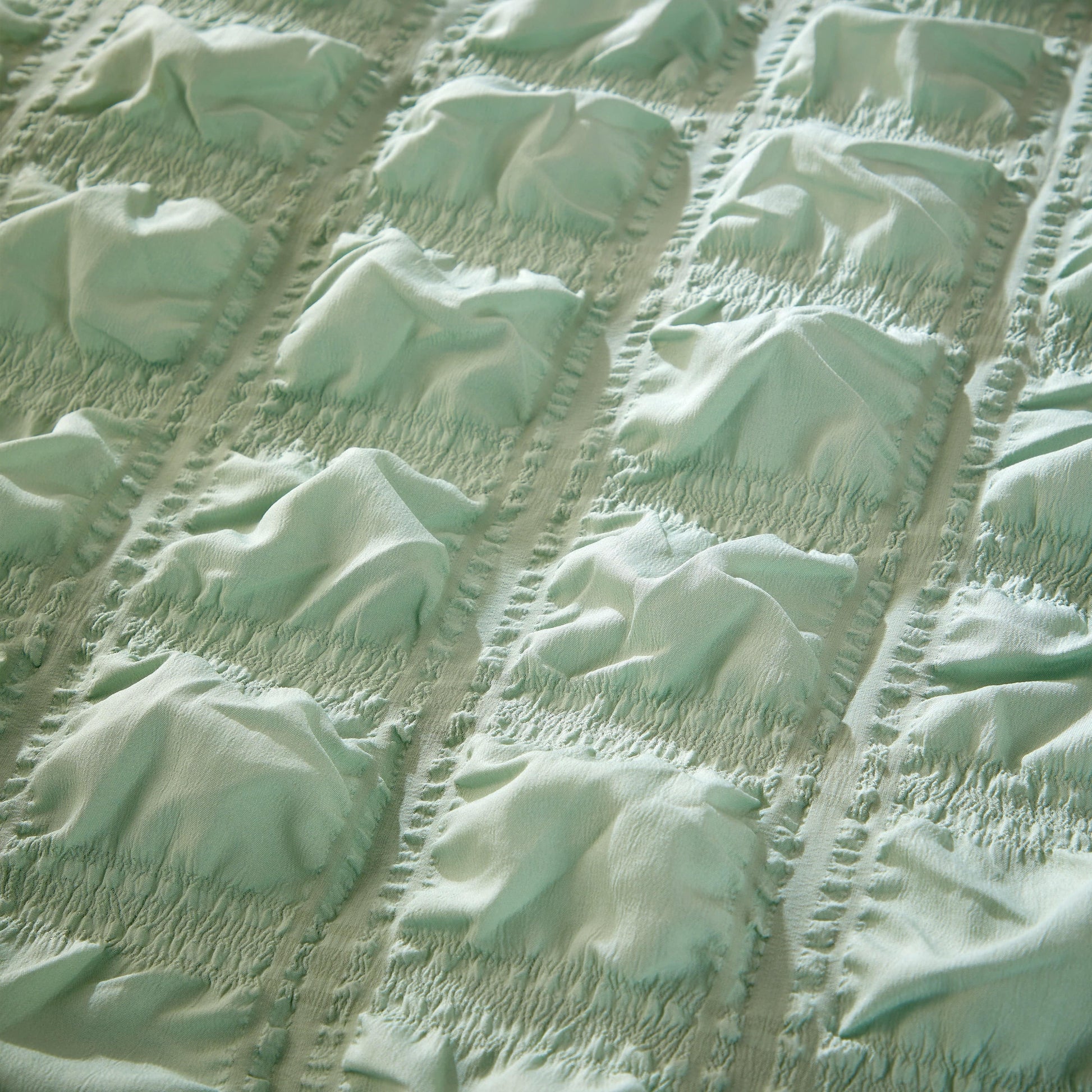 Elegant sage green quilted duvet cover with matching pillowcases from OLIVIA ROCCO, highlighting ultra-soft microfibre material for a plush sleep experience.