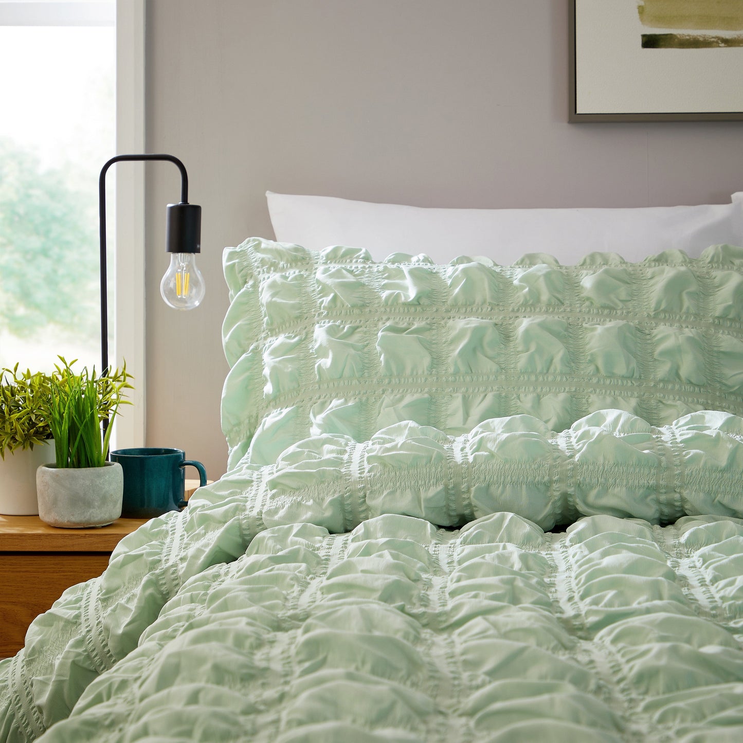 Luxurious Soho Sage Green Microfibre Duvet Cover Set featuring quilted texture, showcasing sophisticated bedding for a serene bedroom decor.