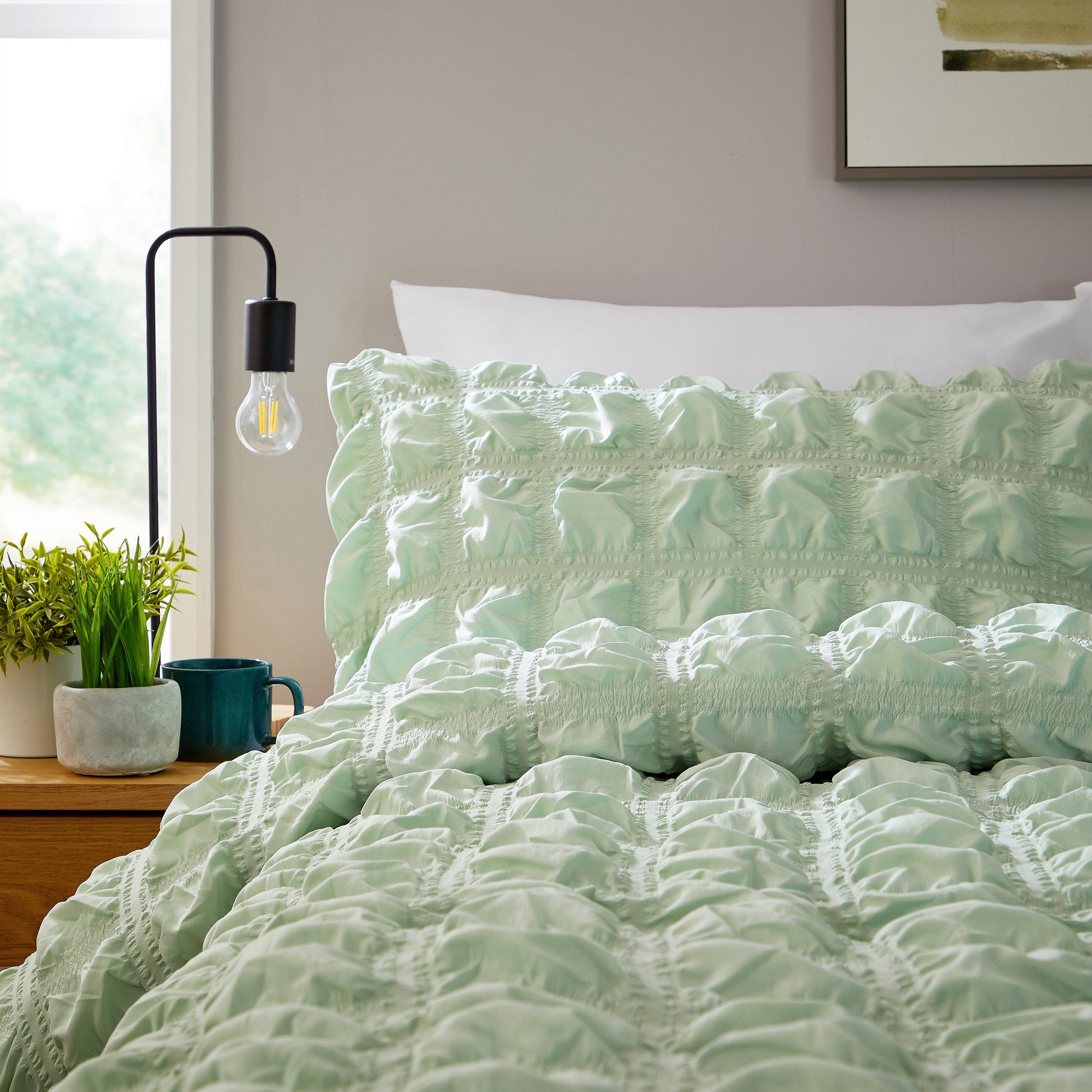Luxurious Soho Sage Green Microfibre Duvet Cover Set featuring quilted texture, showcasing sophisticated bedding for a serene bedroom decor.