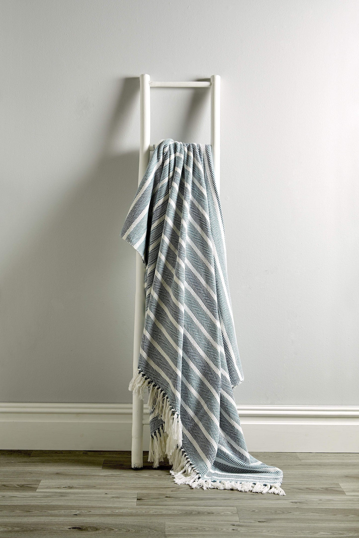 Close-up view of the eco-friendly Zara Pure Cotton Throw by OLIVIA ROCCO, featuring sumptuous texture and stylish tassels, highlighting its eco-conscious design and artisan quality.