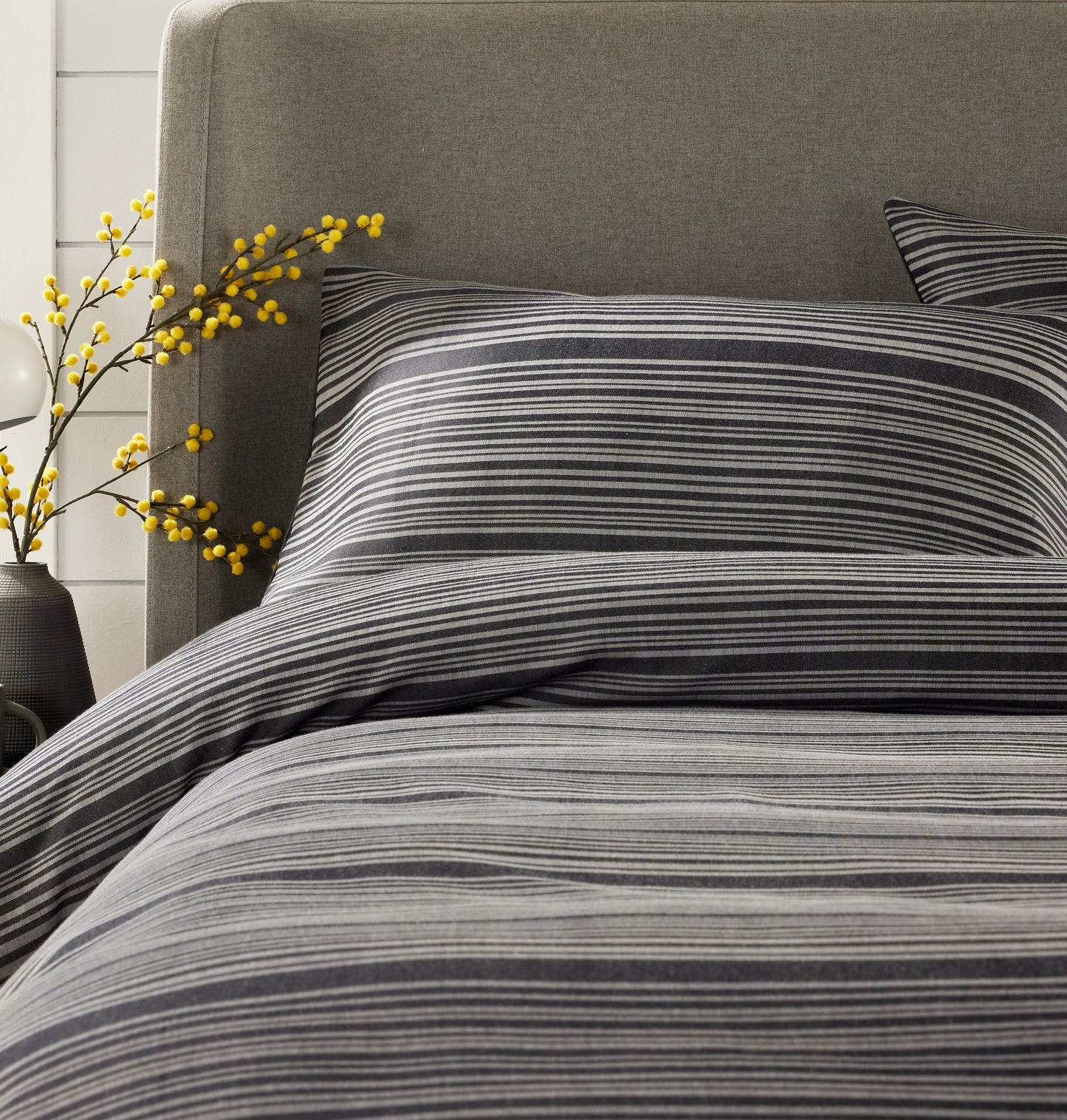 Full view of OLIVIA ROCCO’s luxurious stripe jacquard duvet cover set styled on a bed, beautifully illustrating the comfort and elegance it brings to any bedroom.