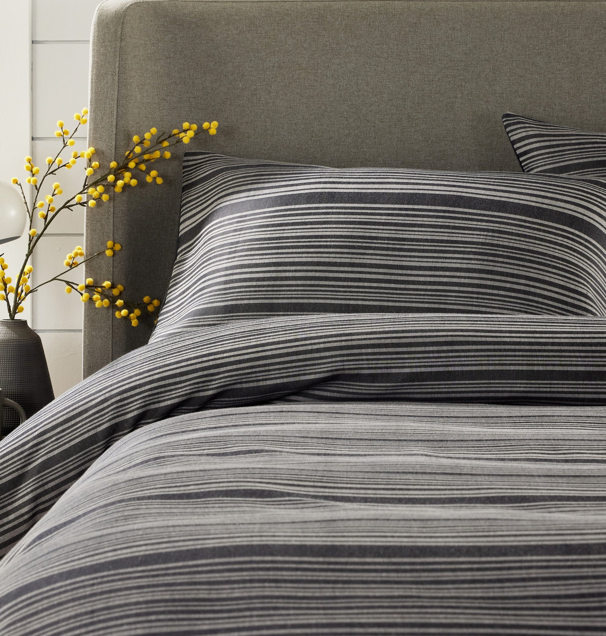 Full view of OLIVIA ROCCO’s luxurious stripe jacquard duvet cover set styled on a bed, beautifully illustrating the comfort and elegance it brings to any bedroom.